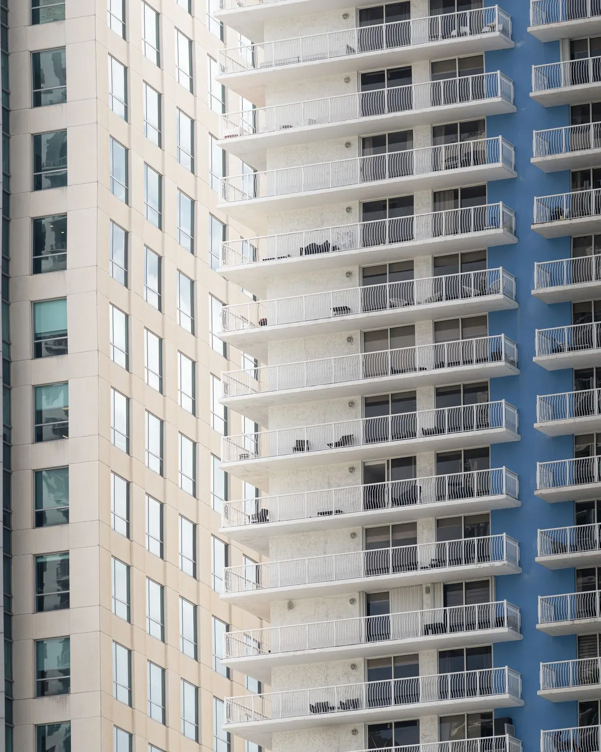 High-rise condominium towers in Miami with rows of white balconies.